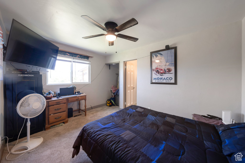 Bedroom featuring carpet flooring, ceiling fan, and an office area
