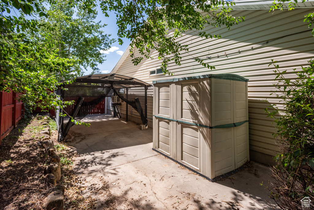 View of patio / terrace with a gazebo and a storage shed
