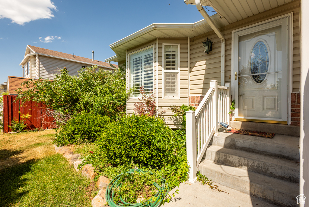 Entrance to property with a lawn