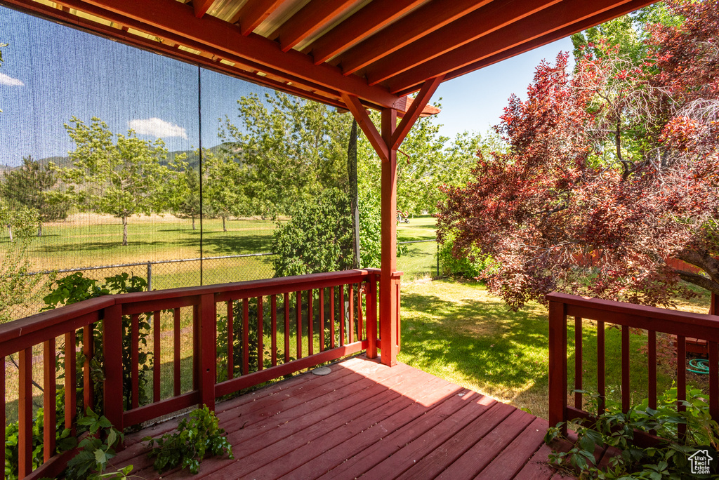 Wooden deck featuring a lawn