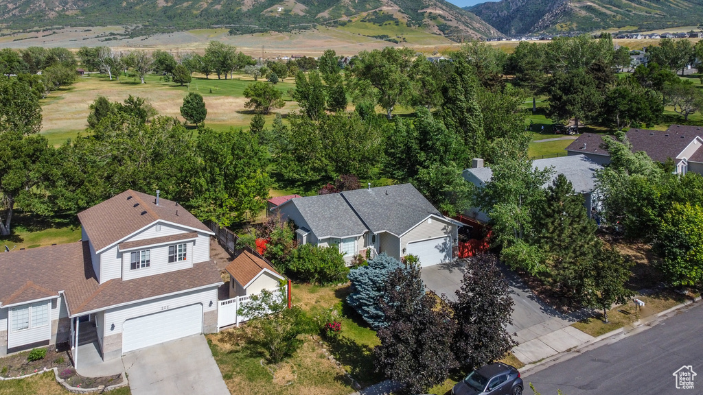 Aerial view of property and surrounding area with a mountain backdrop