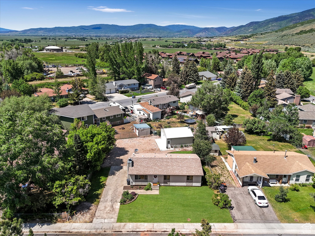 Aerial perspective of suburban area featuring a mountainous background