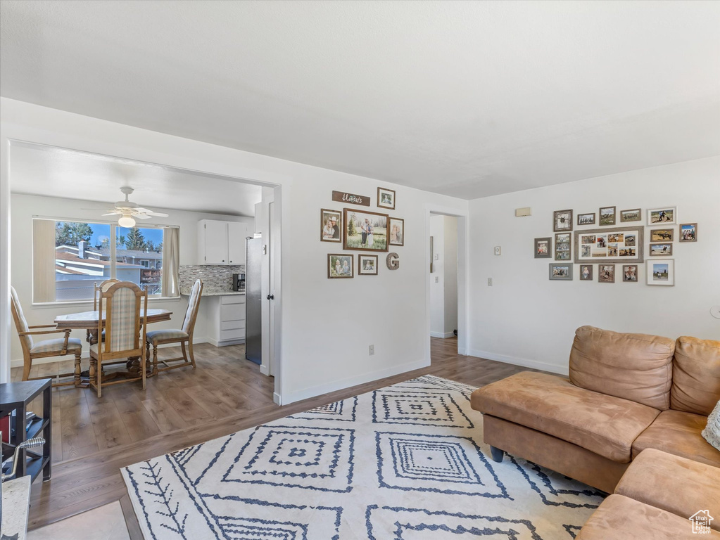 Living area featuring wood finished floors and ceiling fan