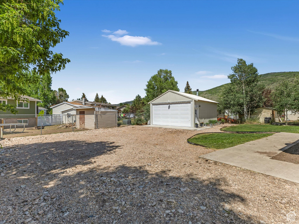 View of front of house with a garage and an outdoor structure