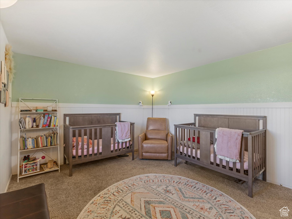 Carpeted bedroom with wainscoting