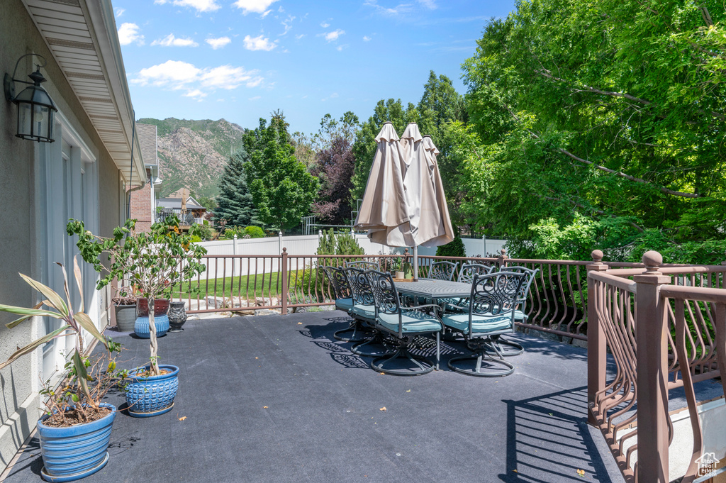 View of patio / terrace with outdoor dining space and a mountain view