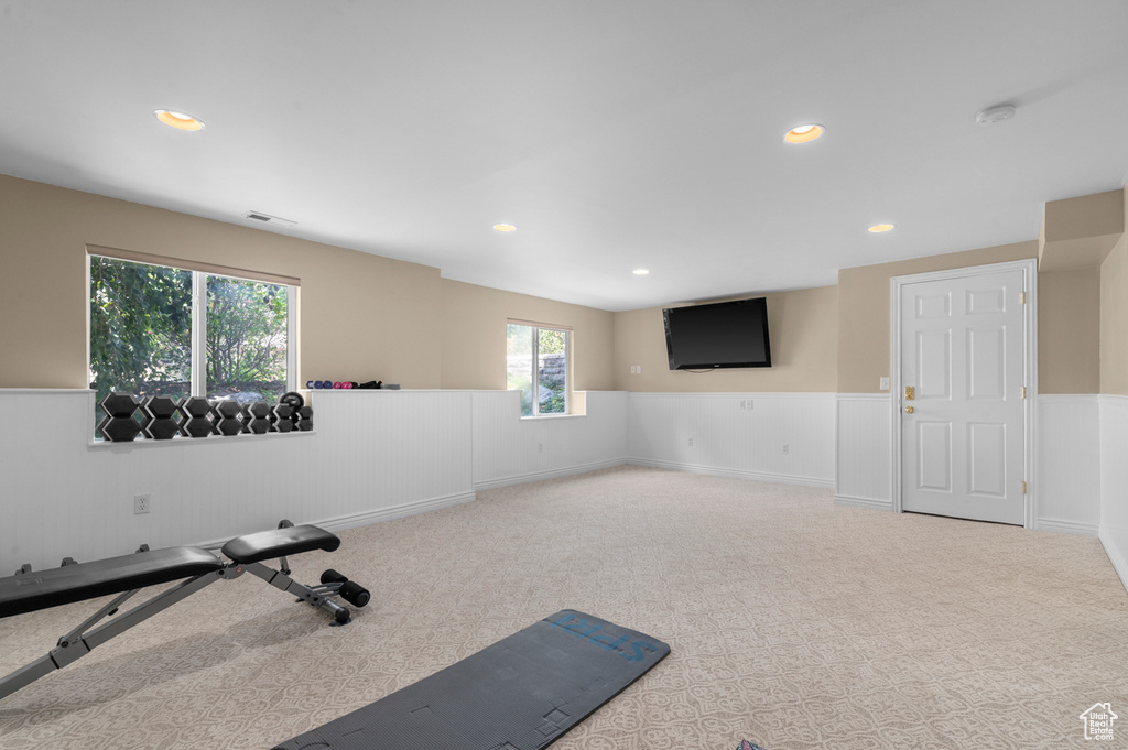 Workout room featuring a wainscoted wall, carpet, and recessed lighting