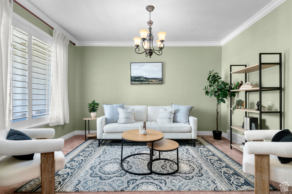 Living area featuring carpet floors, ornamental molding, a chandelier, and plenty of natural light