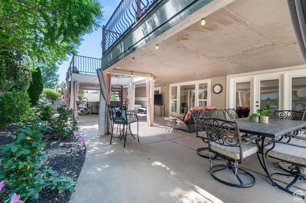 View of patio featuring stairway and outdoor dining area
