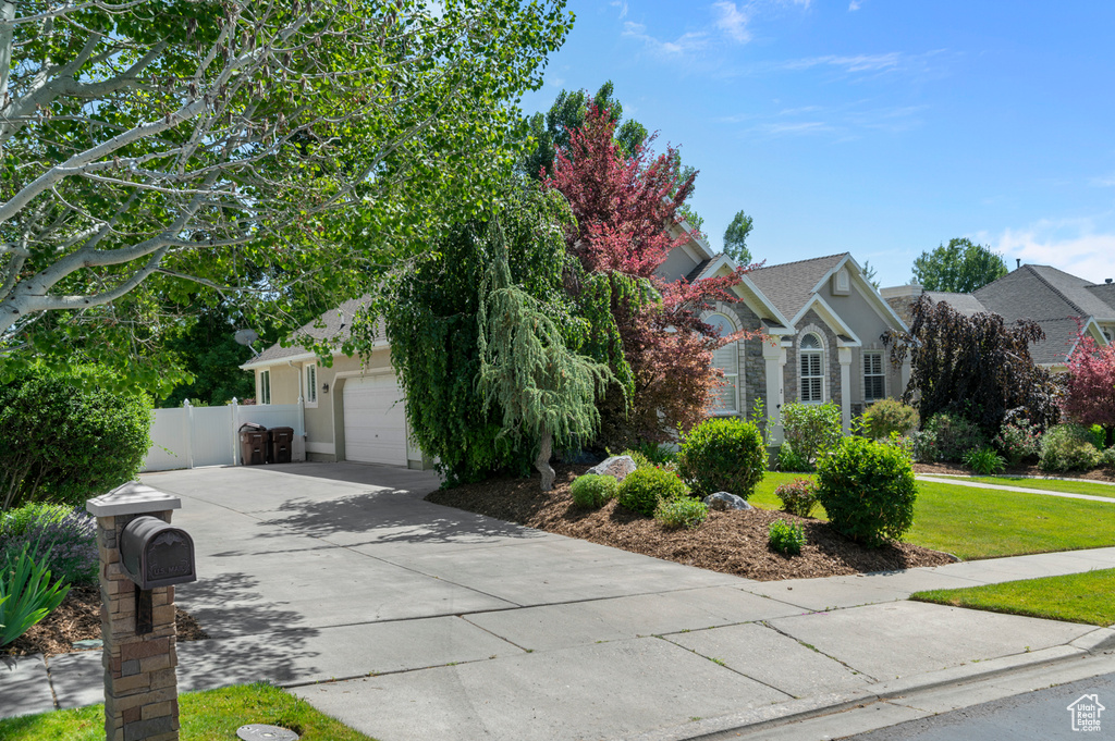 Obstructed view of property featuring a garage and driveway