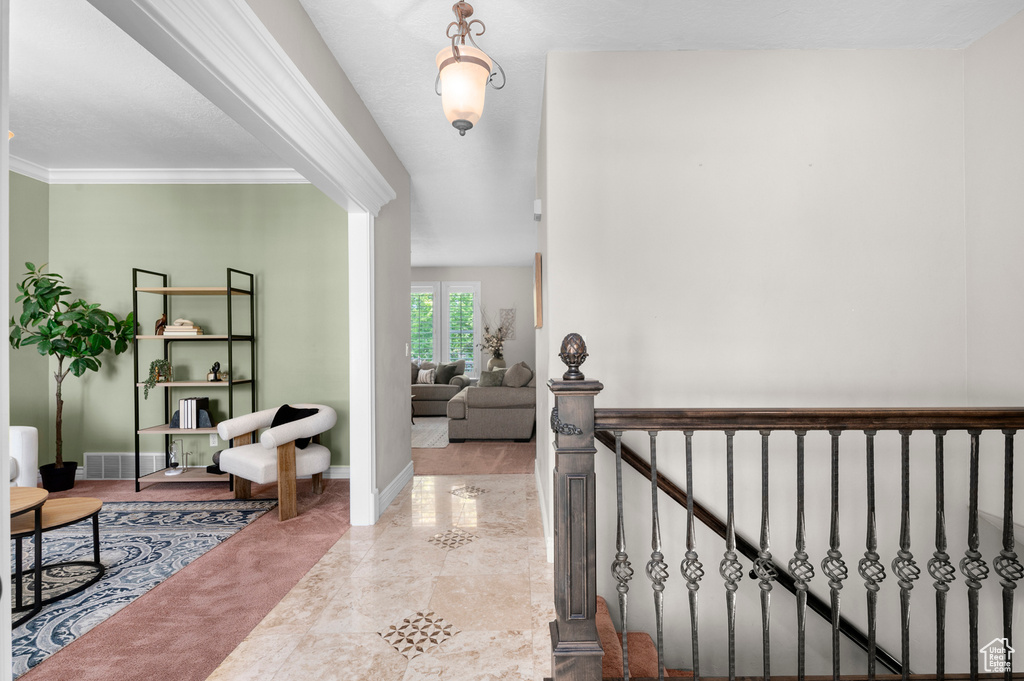 Hallway with baseboards and ornamental molding