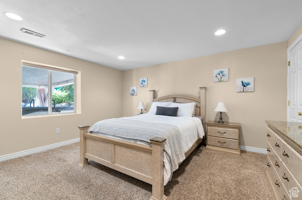 Bedroom featuring light carpet and recessed lighting