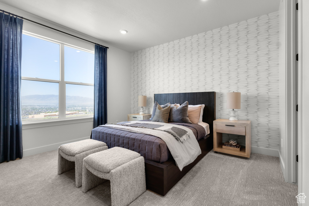 Carpeted bedroom with wallpapered walls and a mountain view