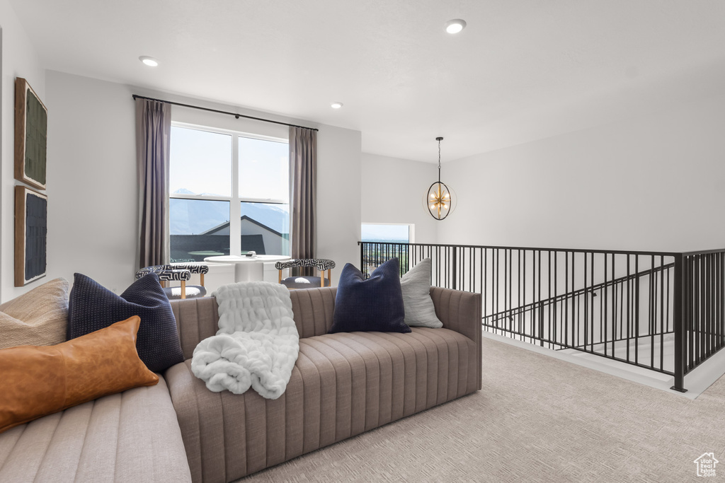 Carpeted living room with a chandelier and recessed lighting
