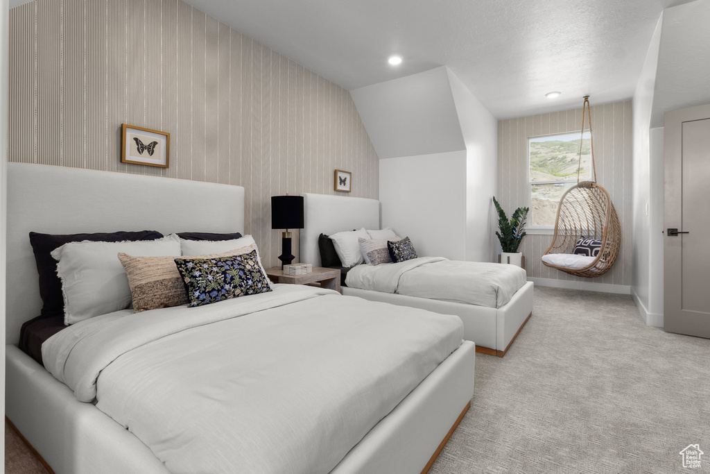 Bedroom with carpet flooring and lofted ceiling