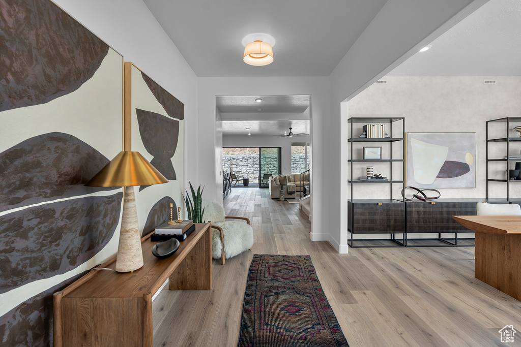 Corridor with wood finished floors and baseboards