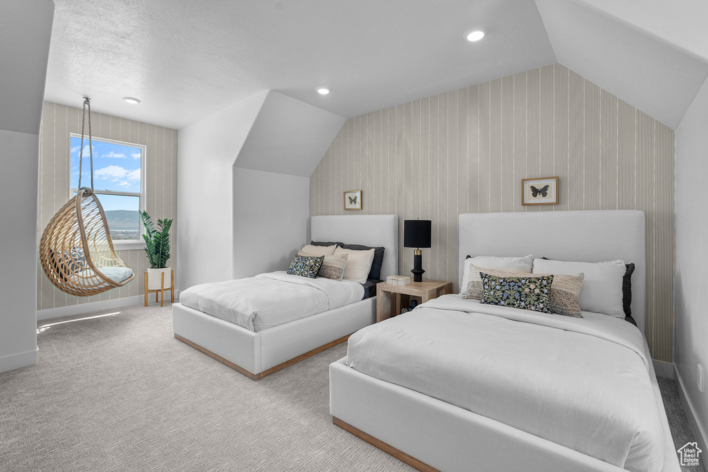Carpeted bedroom with lofted ceiling and recessed lighting