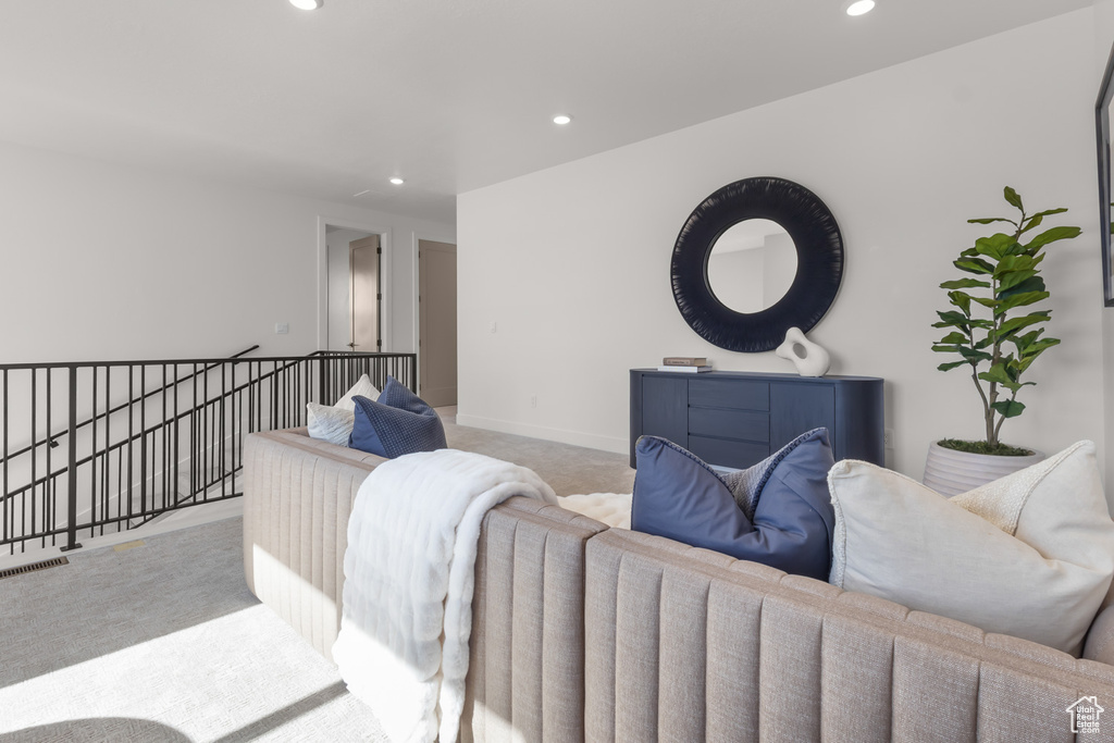 Carpeted living room with recessed lighting