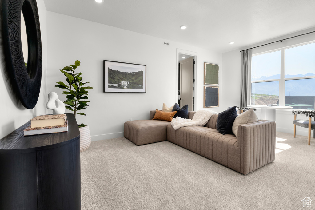 Living room featuring light colored carpet and recessed lighting