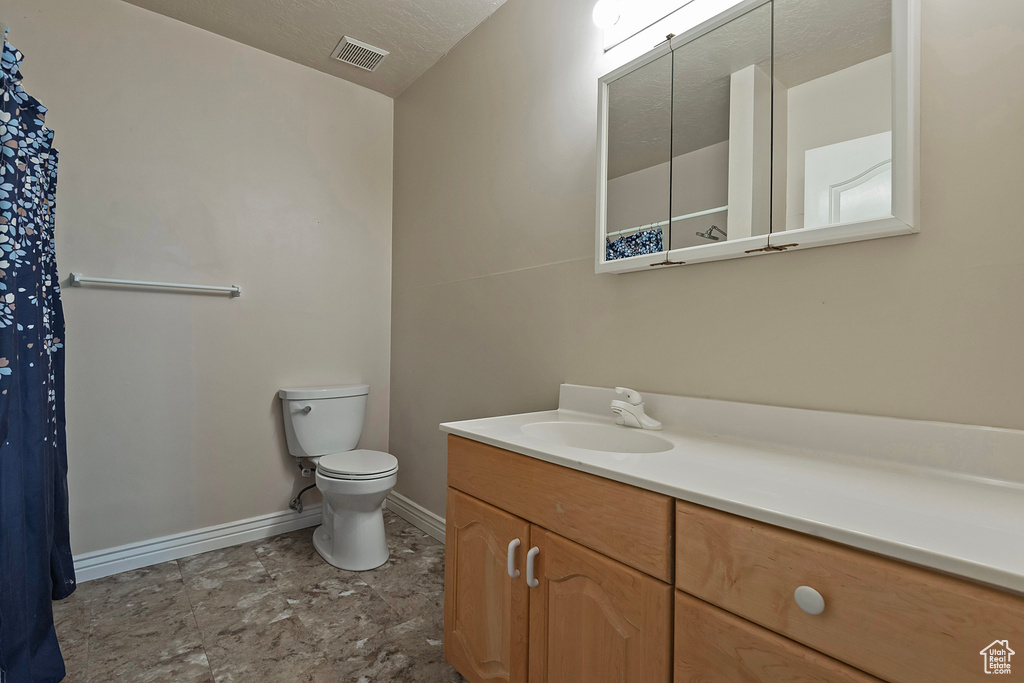 Full bathroom with vanity and stone finish floors