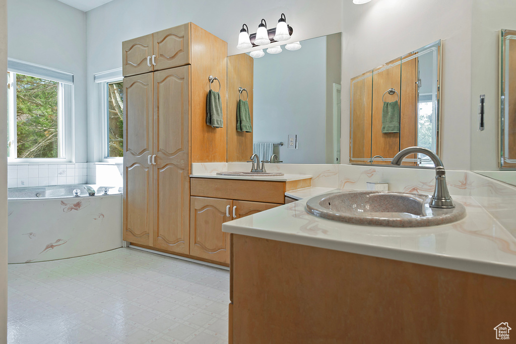 Bathroom featuring vanity and a garden tub