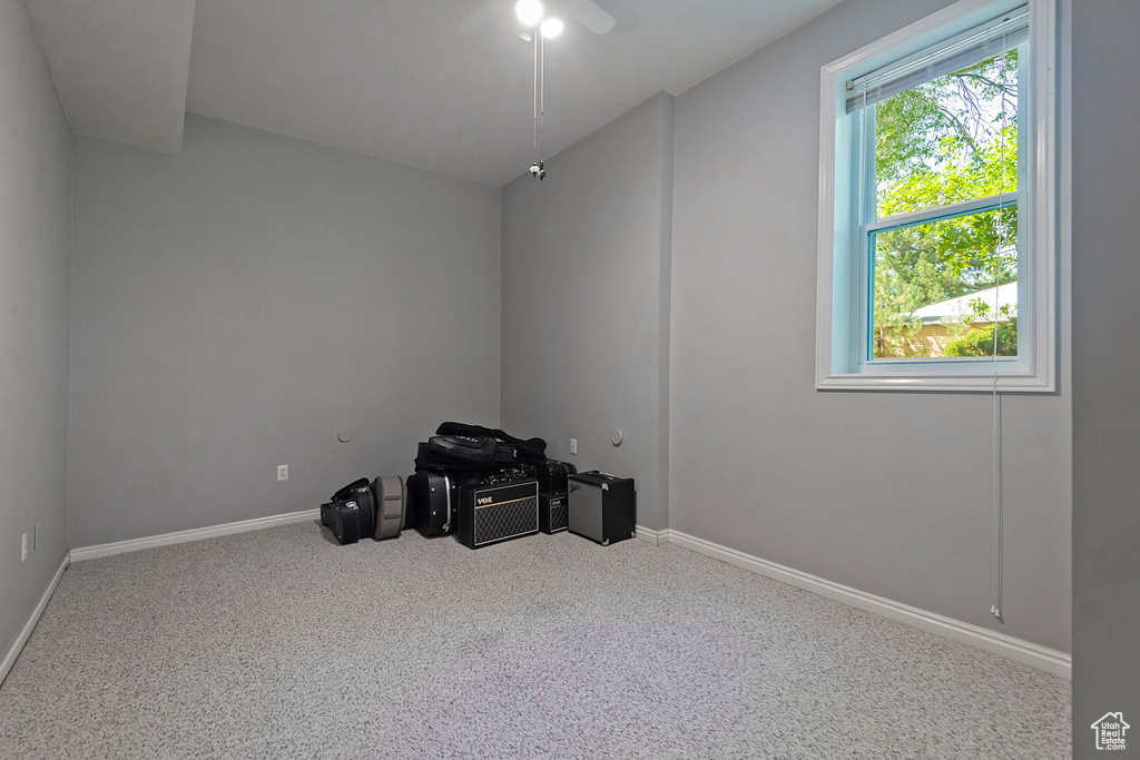 Spare room featuring carpet and ceiling fan