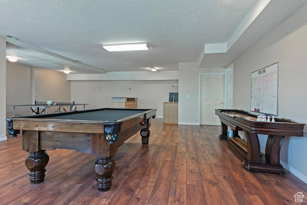 Game room featuring hardwood / wood-style flooring, billiards, and a textured ceiling