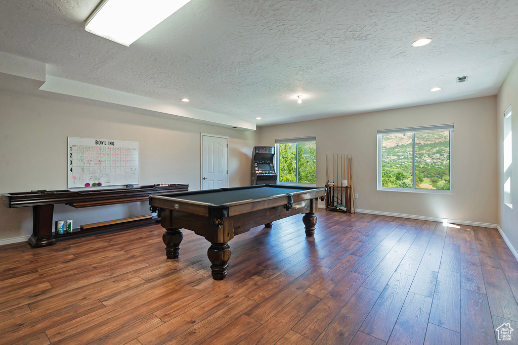 Recreation room featuring a textured ceiling, wood finished floors, billiards table, and recessed lighting