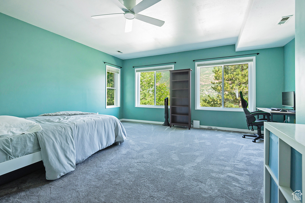 Bedroom featuring carpet floors, an office area, and ceiling fan