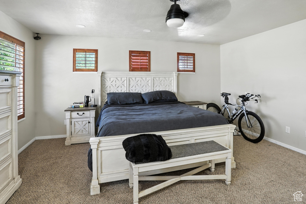 Bedroom with carpet, multiple windows, a ceiling fan, and recessed lighting