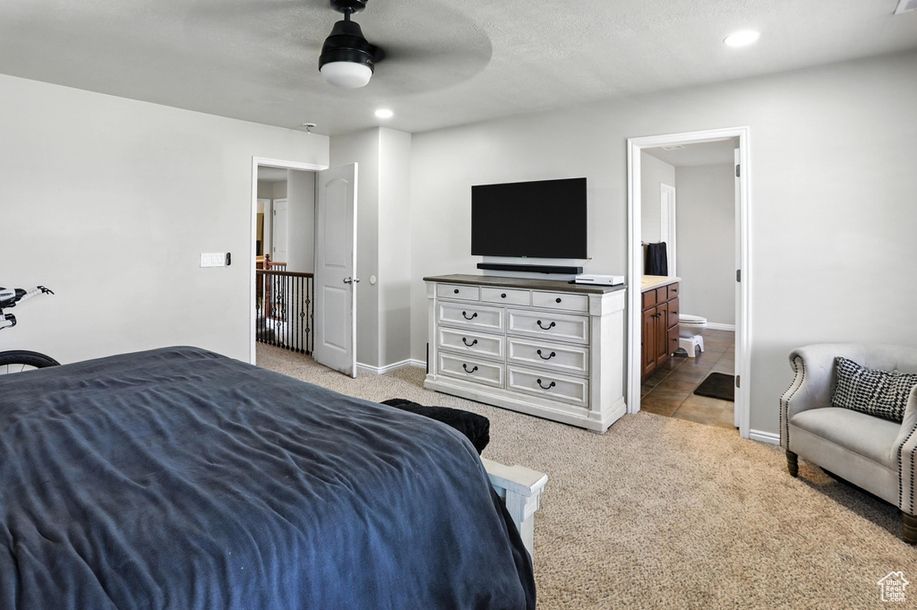Bedroom with light carpet, ensuite bath, recessed lighting, and ceiling fan