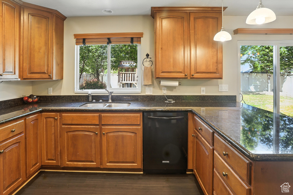 Kitchen featuring a peninsula, plenty of natural light, and brown cabinets