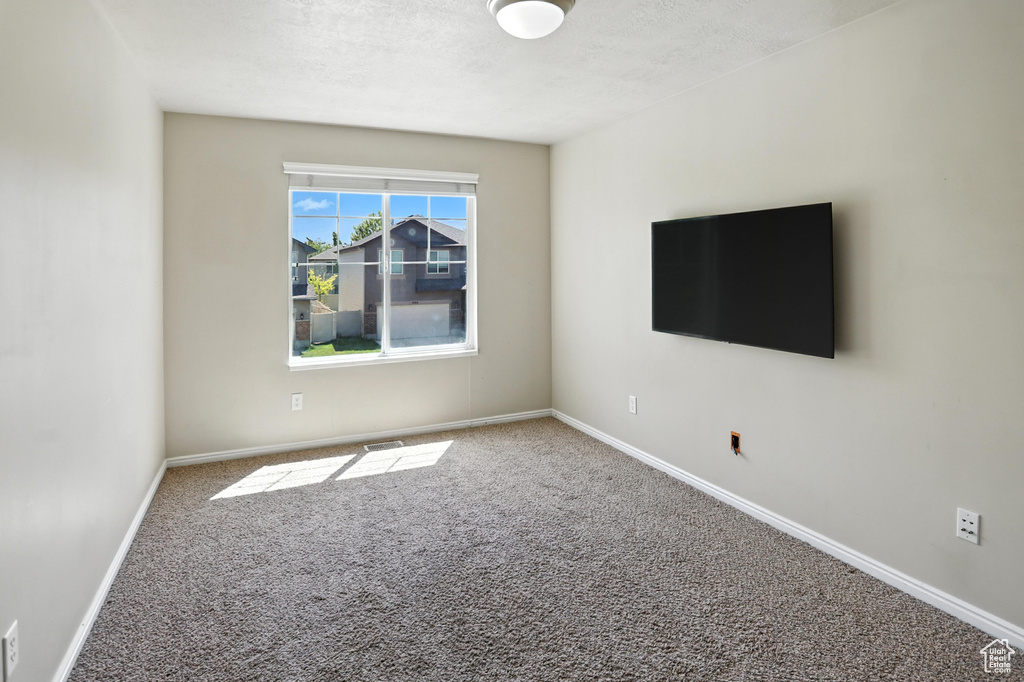 Empty room with carpet floors and baseboards