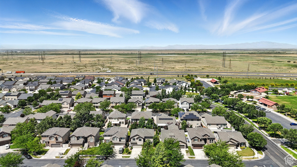 Aerial perspective of suburban area with a mountainous background