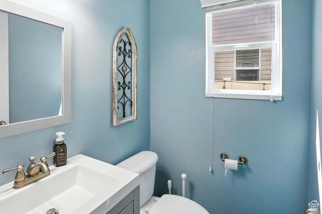 Half bath featuring toilet and vanity