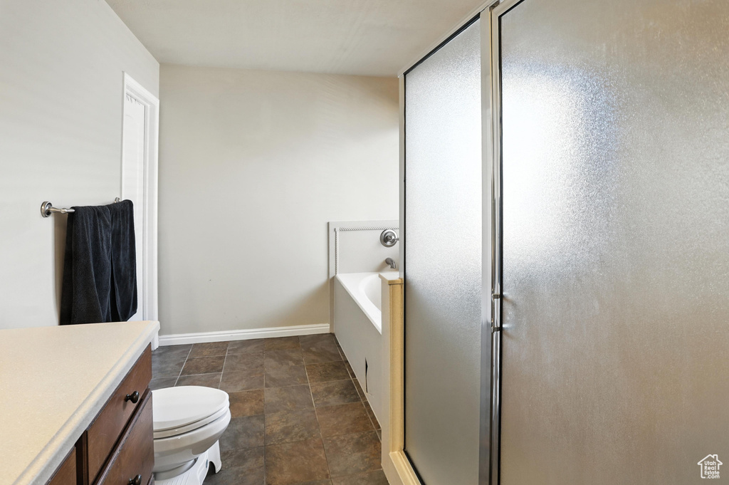 Full bath featuring vanity, a stall shower, and a garden tub