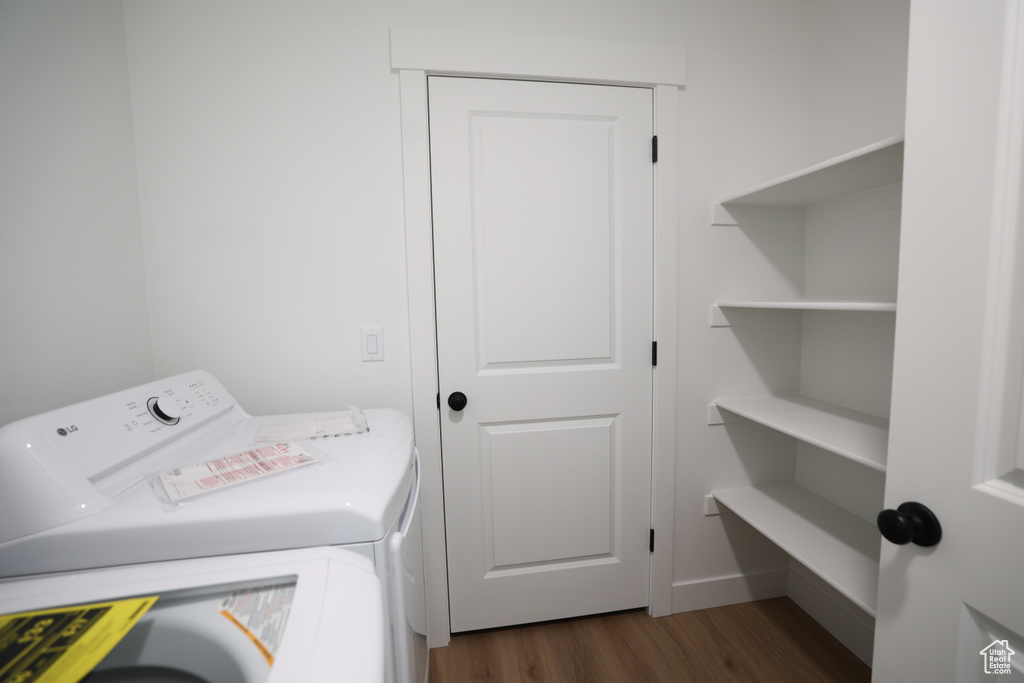 Laundry area featuring dark wood-style flooring and washing machine and dryer