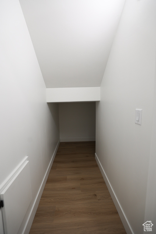 Bonus room with wood finished floors and vaulted ceiling