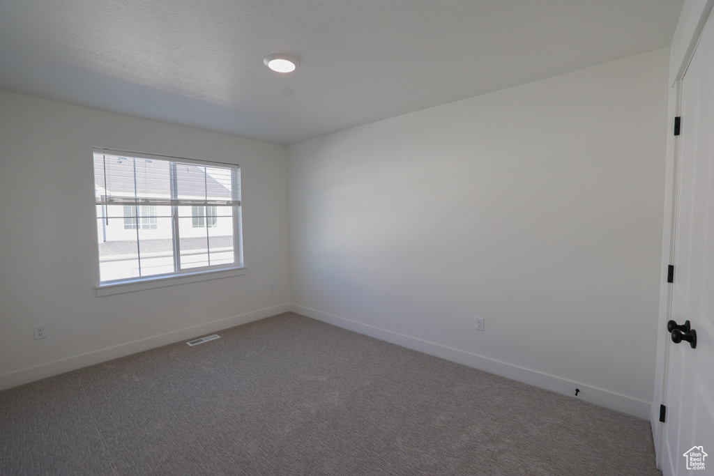 Spare room with carpet flooring and baseboards