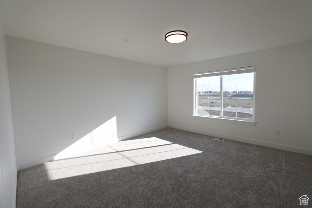 Unfurnished room with carpet and baseboards