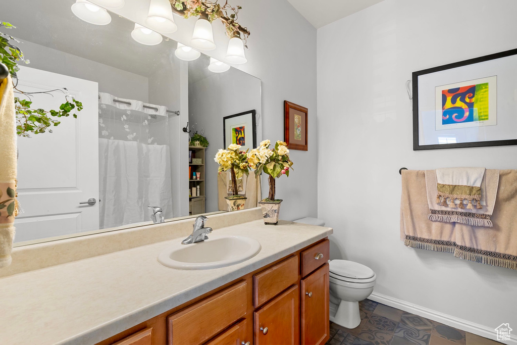 Full bath with vanity and a shower with curtain