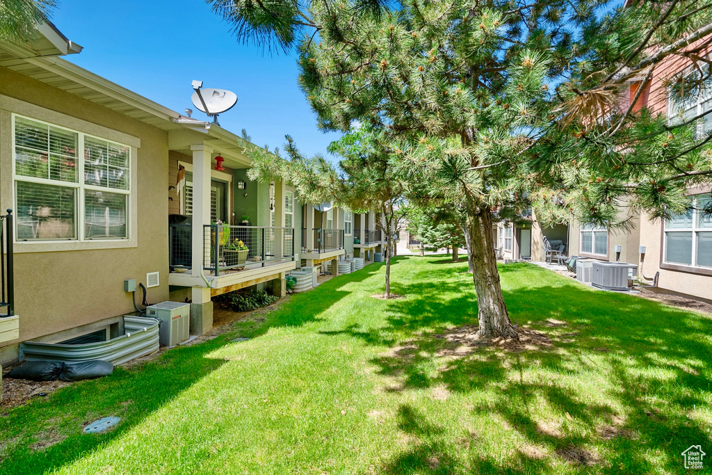 View of grassy yard featuring a deck