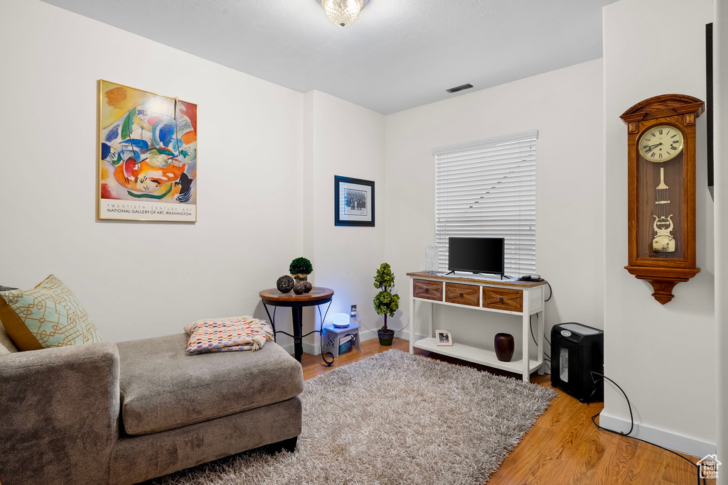 Living area featuring light wood-style floors and baseboards
