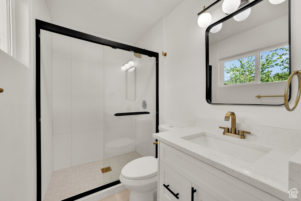 Full bathroom featuring vanity and a stall shower
