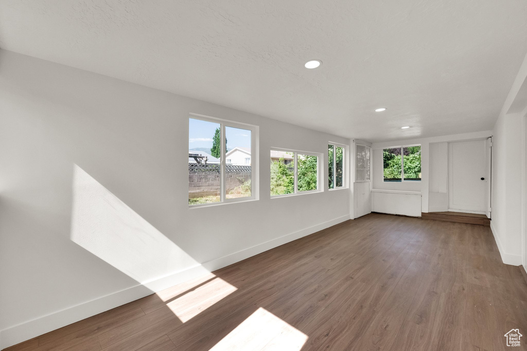 Spare room featuring wood finished floors and recessed lighting