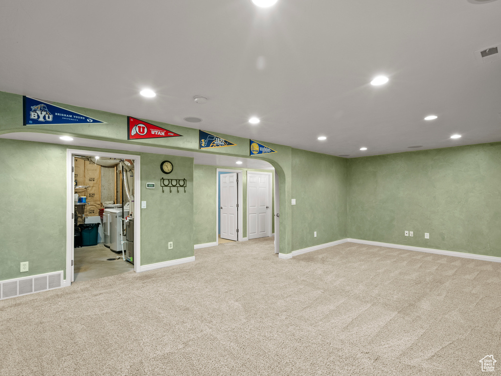 Unfurnished room with carpet flooring, arched walkways, and recessed lighting