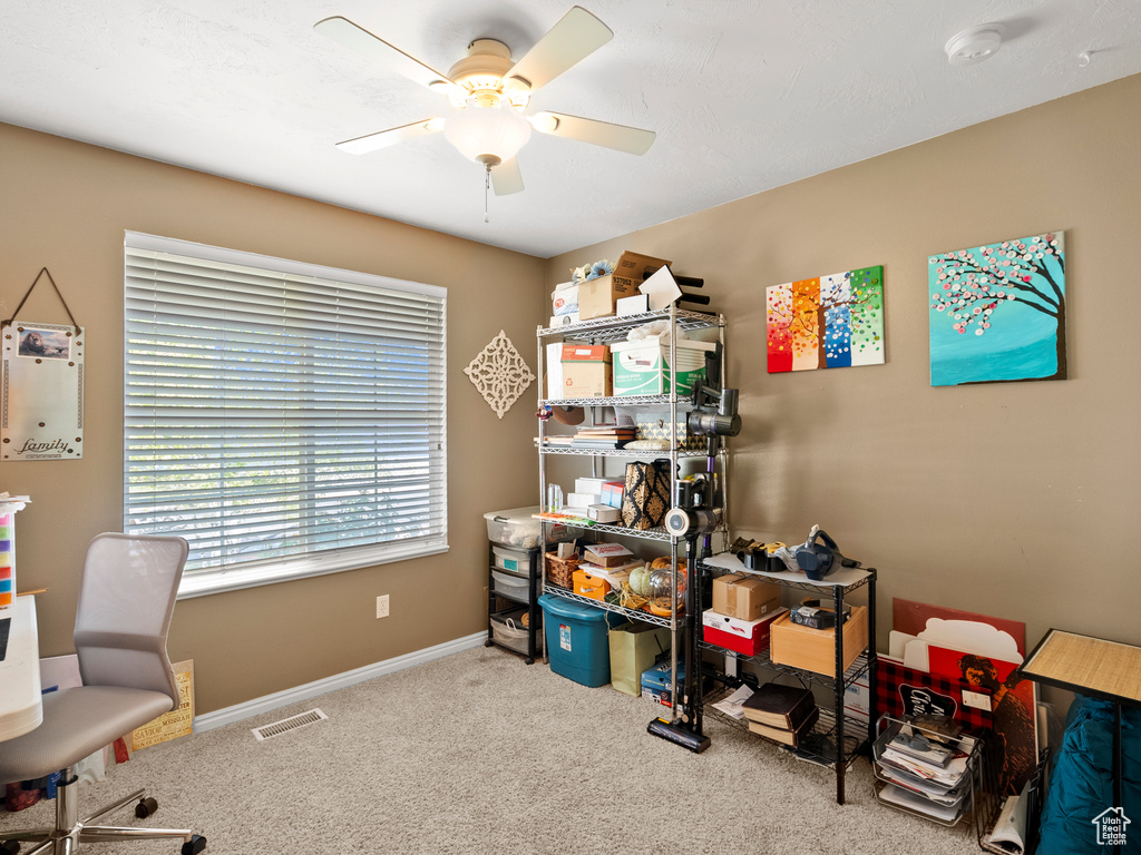 Office space featuring ceiling fan and carpet