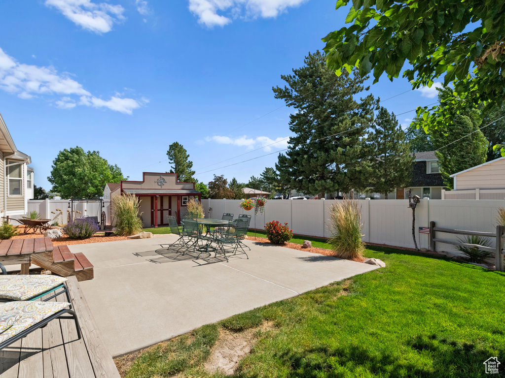 Fenced backyard with a patio area and outdoor dining space