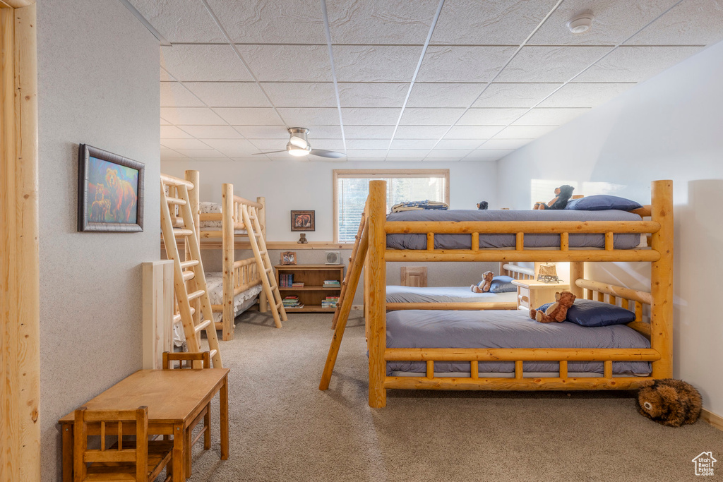 Bedroom featuring carpet flooring and a paneled ceiling