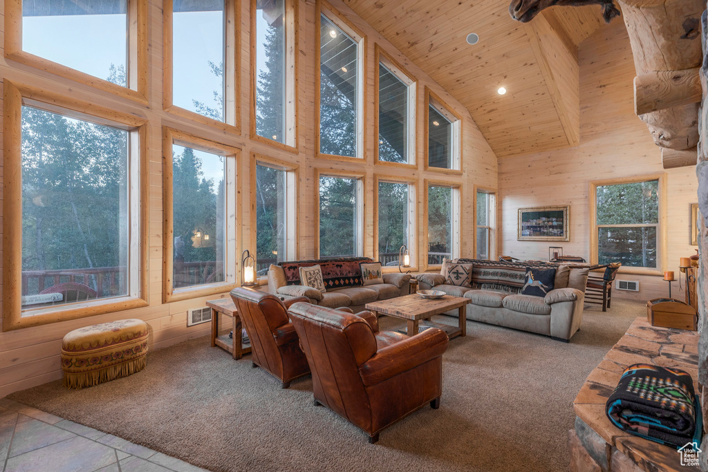 Carpeted living area with high vaulted ceiling, wood ceiling, and recessed lighting